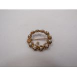 A 9ct gold brooch set with pearls, one loose