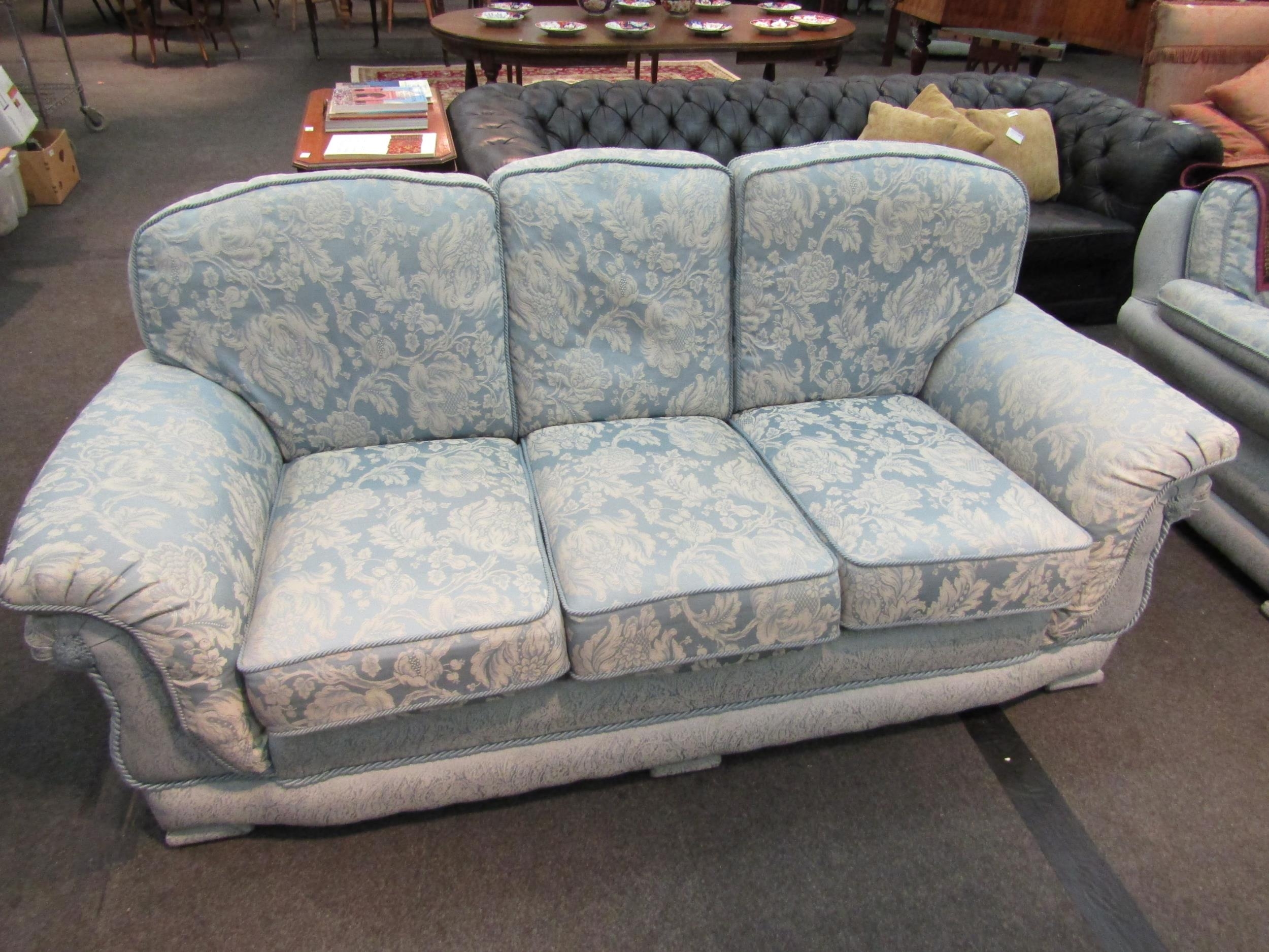 A classic style three-seater sofa, rope trim, loose cushions, pale blue floral upholstery, Life