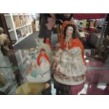 Two Staffordshire figures of girls wearing hoods