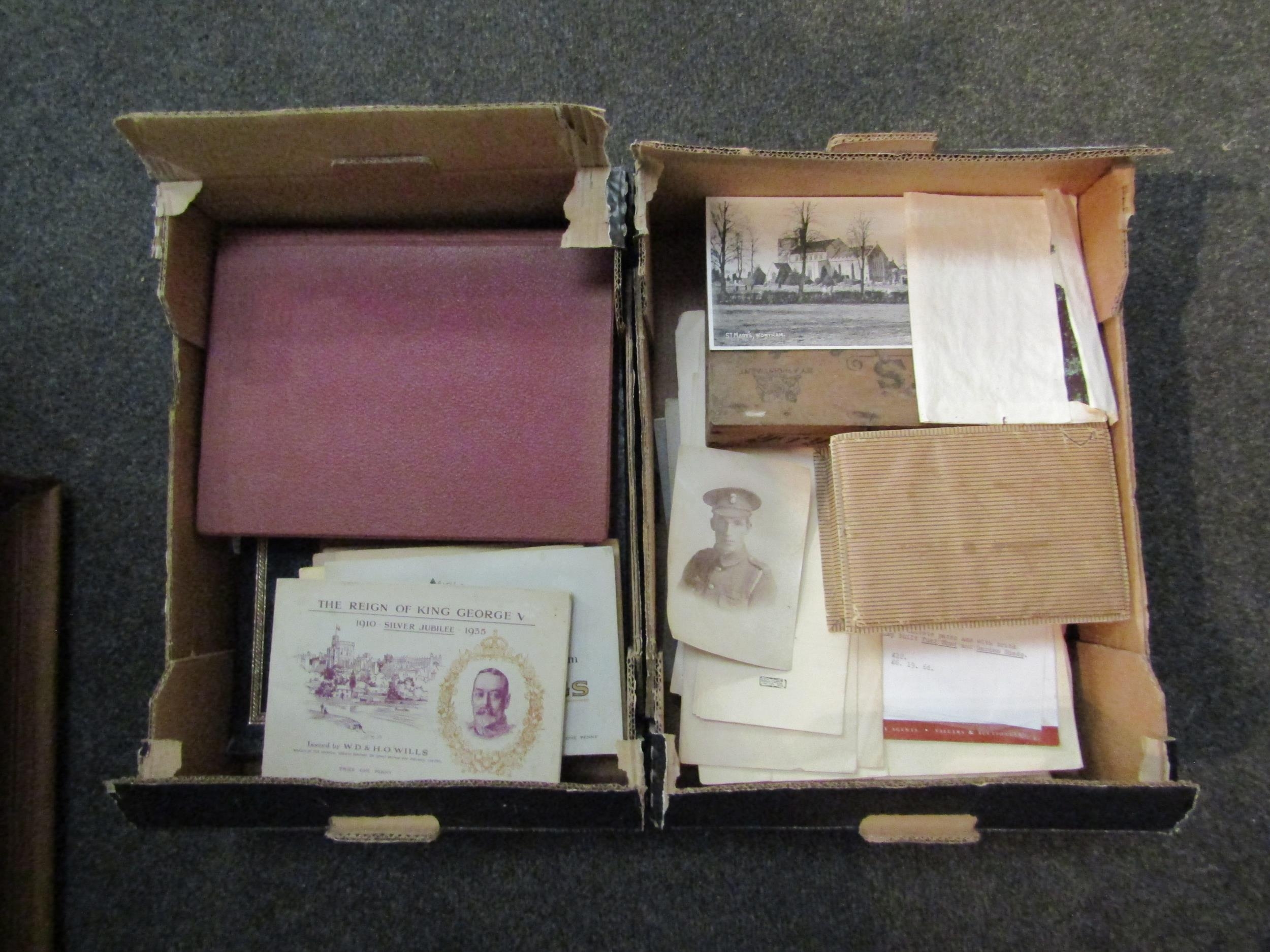 Two boxes containing two postcard albums, one containing mainly Continental examples, the other
