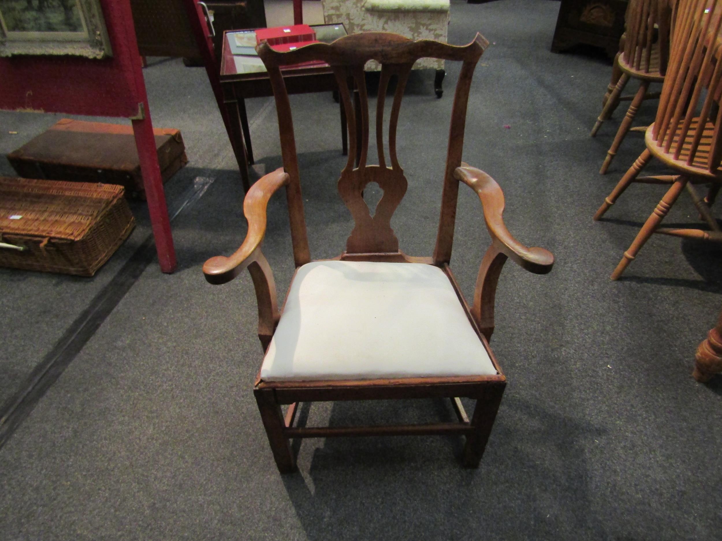 A 19th Century elbow chair with pierced splat on stretcher base