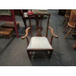 A 19th Century elbow chair with pierced splat on stretcher base