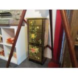 A chinoiserie lacquered six drawer floor-standing jewellery cabinet with lift top and hinged side