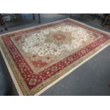 A Turkish wool rug in cream and red tones, classical design, 2.8 metres x 3.8 metres