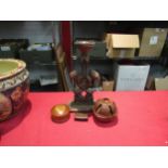 A collection of treen; carved ethnic candlestick, brazil nut seed pod, wooden pot and stamp box (a/