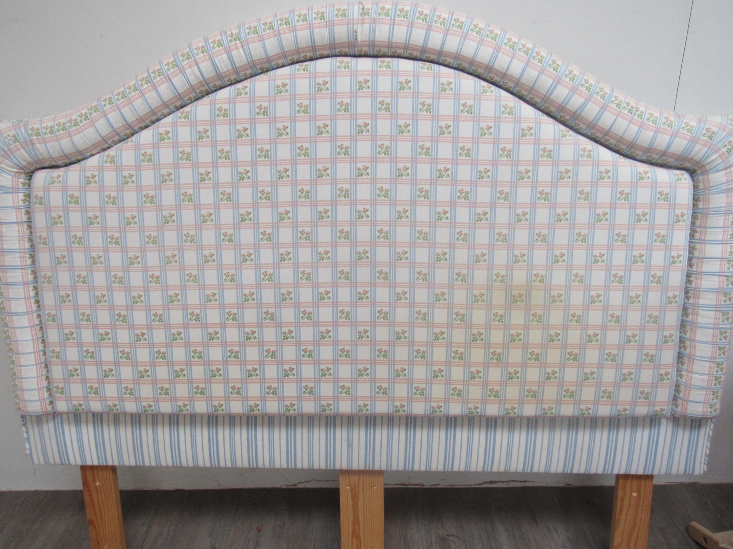 An upholstered and padded headboard, double bed size, pink and blue lattice floral pattern and two