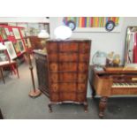 An early 20th Century mahogany and burr walnut veneered chest of six drawers with shaped front on