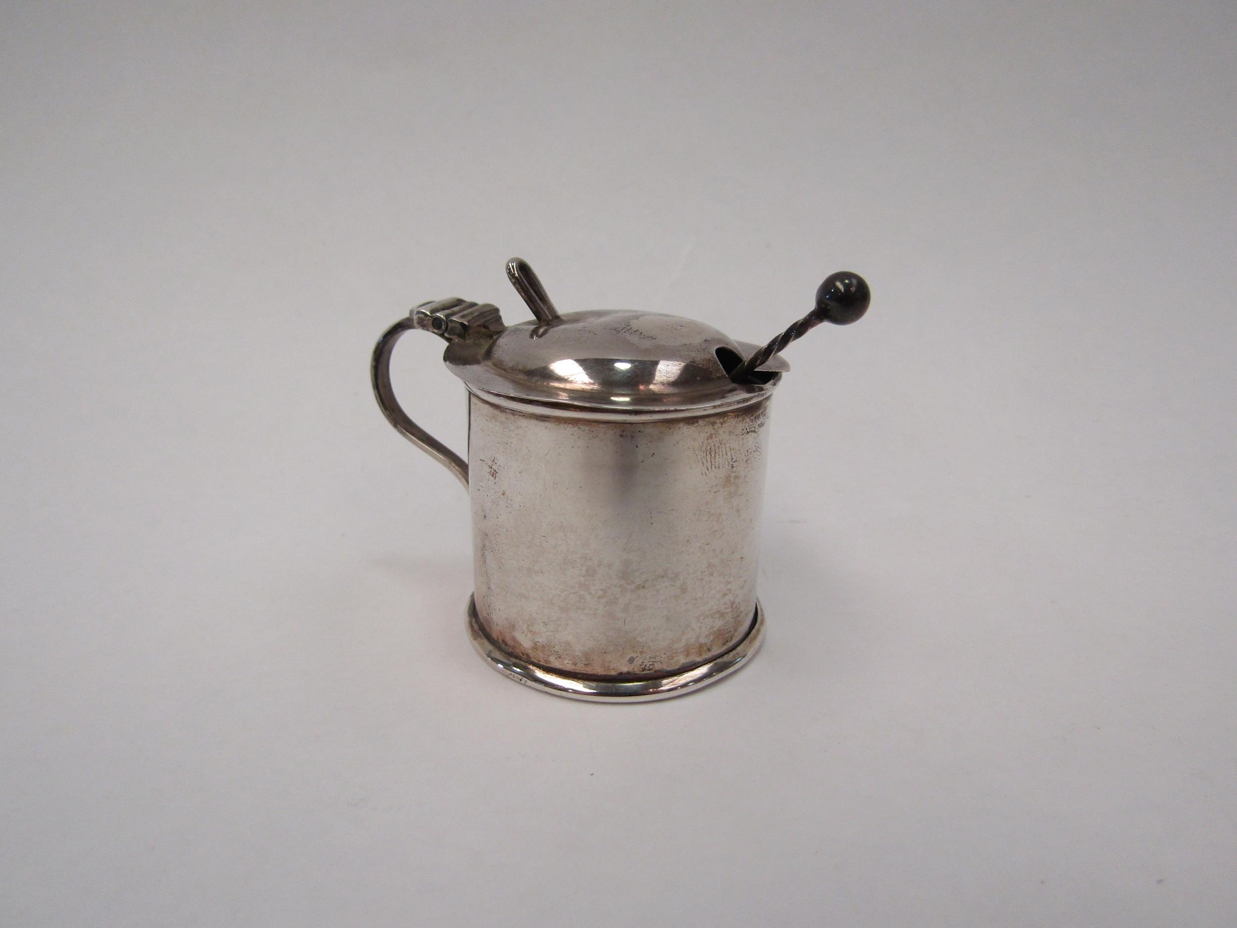 A silver mustard pot and spoon