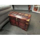 A Middle Eastern hardwood domed chest with brass inlaid decoration