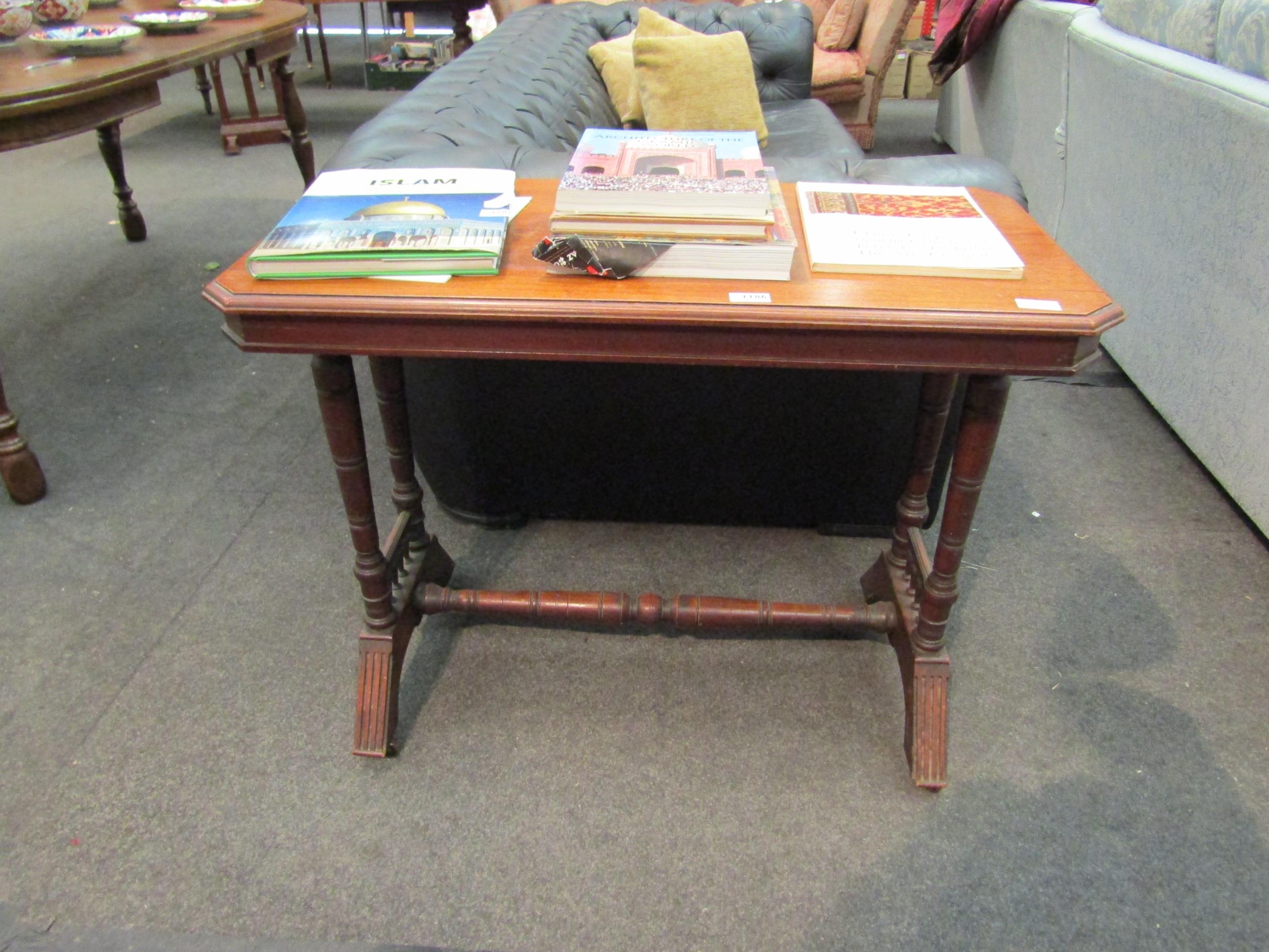 A late Victorian walnut side table, the canted corner top over ring-turned supports to spindle