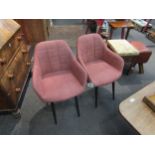 A set of four peach coloured modern tub chairs with tubular legs