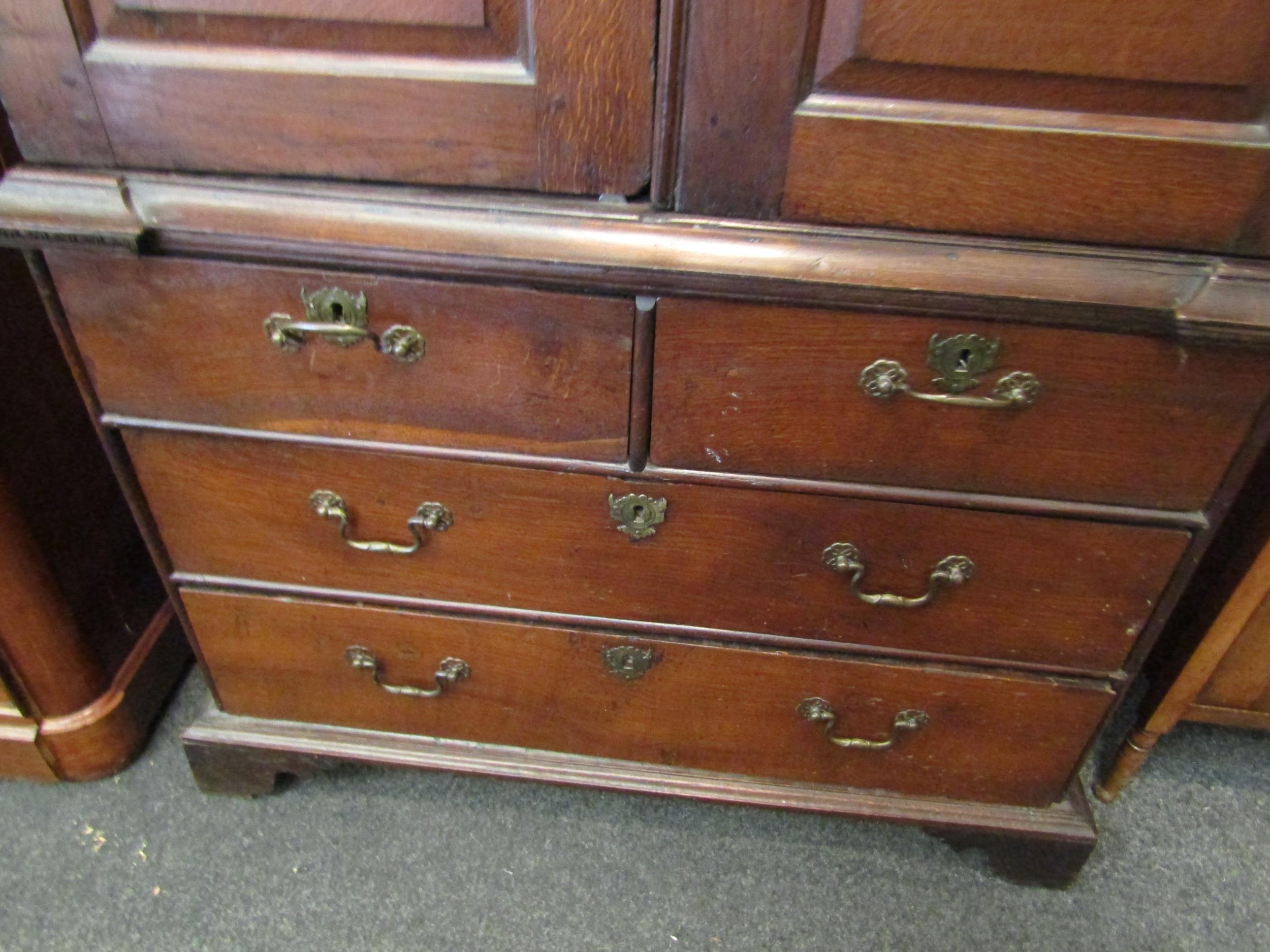 An early to mid 18th Century oak slim two door cupboard over two over two drawer base with swan neck - Image 3 of 5