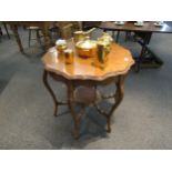 A 1930s walnut occasional table with pie crust top, carved legs to under-tier, 73cm high