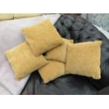 A set of five yellow/mustard colour cushions