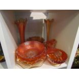 Nine pieces of orange carnival glass including two vases, bowls, dishes and jugs