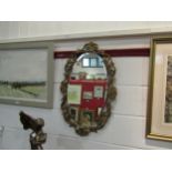 An oval gilt framed wall mirror, 75cm x 46cm total