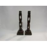 A pair of Arts & Crafts oak candlesticks possibly Glasgow school the turned sconces on a corkscrew