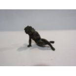 A bronze figure of a recumbent cherub, 5cm tall, 7cm long