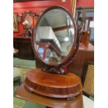 A William IV mahogany dressing chest oval mirror on spiral twist horns and carved scrolling leaf,