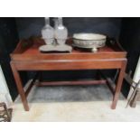 A George III revival mahogany butlers tray on stand occasional table, the wavy backed upstand with