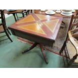 A reproduction envelope table with leather inserts, pedestal base with reeded legs, paw feet to