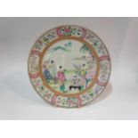A Japanese polychrome porcelain plate with central figural scene, floral borders, 30.5cm diameter.