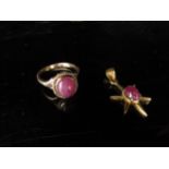 A gold ring with cabochon ruby in rope setting, unmarked. Size O, 3.9g and a cabochon ruby