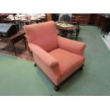 Circa 1890 a pair of armchairs in the manner of "Maples & Co" the scrolled back rest and arms over