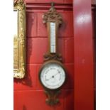 An AWG & Mage Ltd., London, carved oak barometer with mercury thermometer