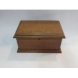 A dovetail jointed oak box containing a large quantity of Wade animals including Zoo Whimsies (R) £