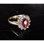 A 9ct gold garnet and cubic zirconia cluster ring. Size P, 2g