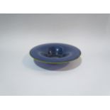 GILLIES JONES: A dark blue glass bowl with yellow rim, 19cm diameter