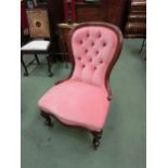 Circa 1850 a walnut spoon back armchair with pink upholstery the deep button back rest over a