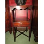 A George III mahogany two tier gentlemans washstand with shaped apron over a single drawer and 'X'