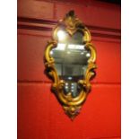 A George II revival gilt wood framed wall mirror with scroll leaf decoration, 50cm x 24cm total