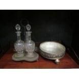A tantualus stand with three associated decanters and dish with grape and vine border (2)