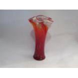 A late 20th Century art glass vase in red with gold foil inclusions and waved rim, 36cm high
