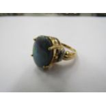 An 18ct gold solid opal and diamond ring. Size N, 8.9g