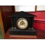A Neo-Classical black slate mantel clock with reeded column supports, with pendulum, no key