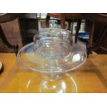 A glass pedestal cake stand with bulbous stem and a glass dome (2)