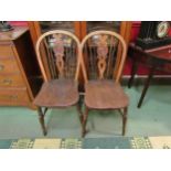 A matching pair of elm wheel/spindle back kitchen chairs