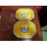 A pair of Chinese yellow and blue glazed dishes with scenes of gent walking through river, character