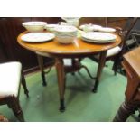 A satin walnut Biedermeier circular top table over turned and tapering legs on carved ebonised