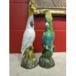 A pair of Mintons majolica cockatoo figures, one in white with yellow crest, the other in green with