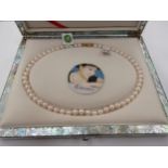 A single strand of pearls, 43cm long, in mother-of-pearl fitted box