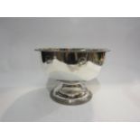 A white metal punch bowl inset with coin detail, gadrooned edge on pedestal base, 25cm diameter