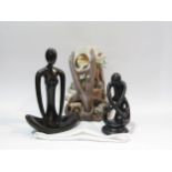 Two modern stylized figures including Yoga pose, together with a candle display in the form of a
