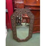 A metal framed octagonal bevel edge wall mirror embossed with Rococo shell form motifs, 74cm high
