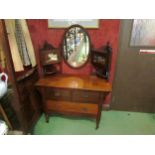 Circa 1890 an Arts & Crafts walnut dressing chest, the finial raised back with central oval mirror