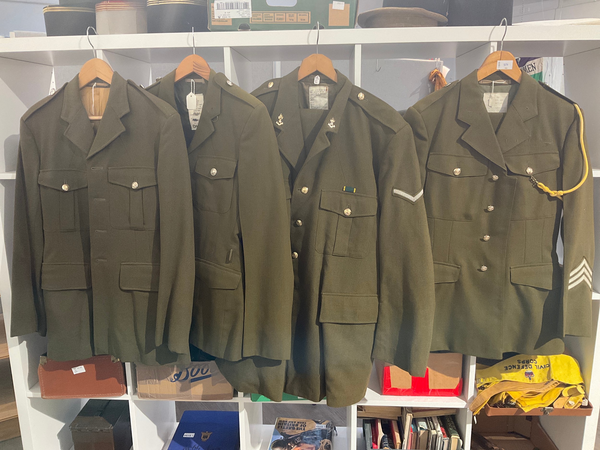 Four post war British army no. 2 service dress jackets, two with trousers, one with insignia